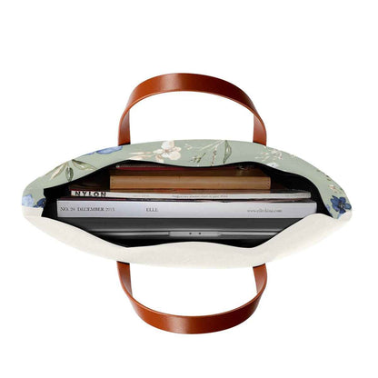 Floral fabric beach tote with brown leather-look handles, open-top view