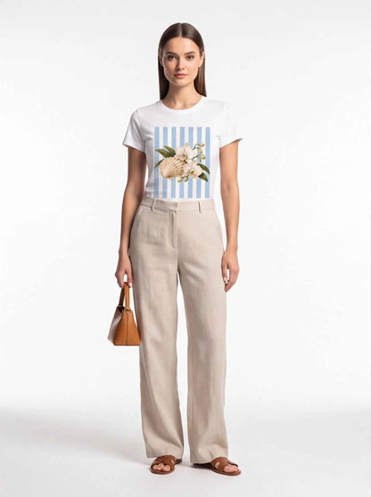 White crewneck t-shirt with blue striped front graphic of seashell and orchids
