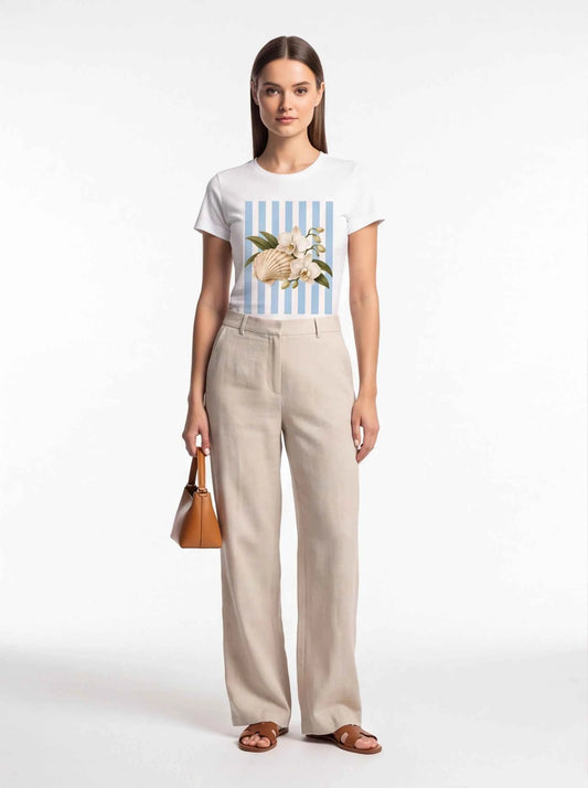 White crewneck t-shirt with blue striped front graphic of seashell and orchids
