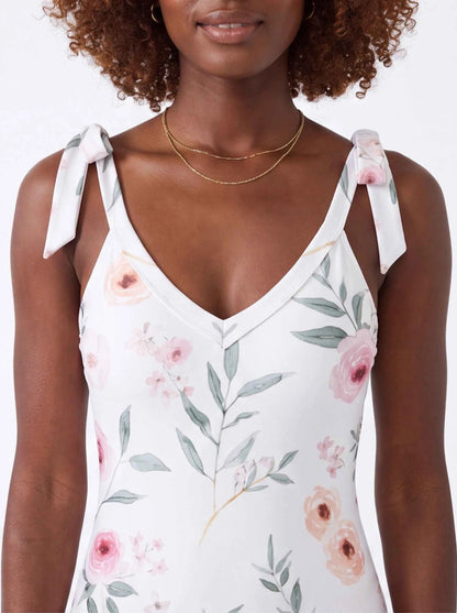 Floral tie-shoulder one-piece swimsuit close-up, white with pink roses and green leaves