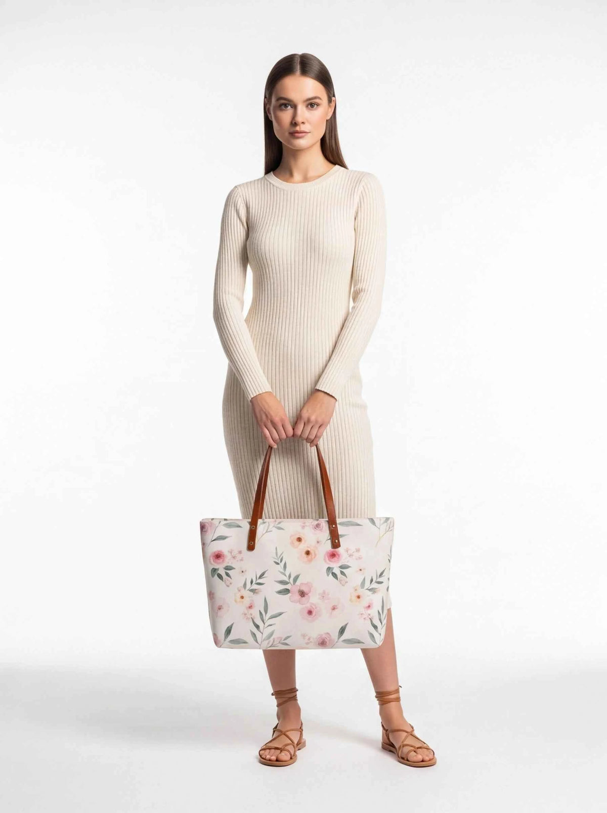 White floral tote bag with pink blossoms and brown leather handles