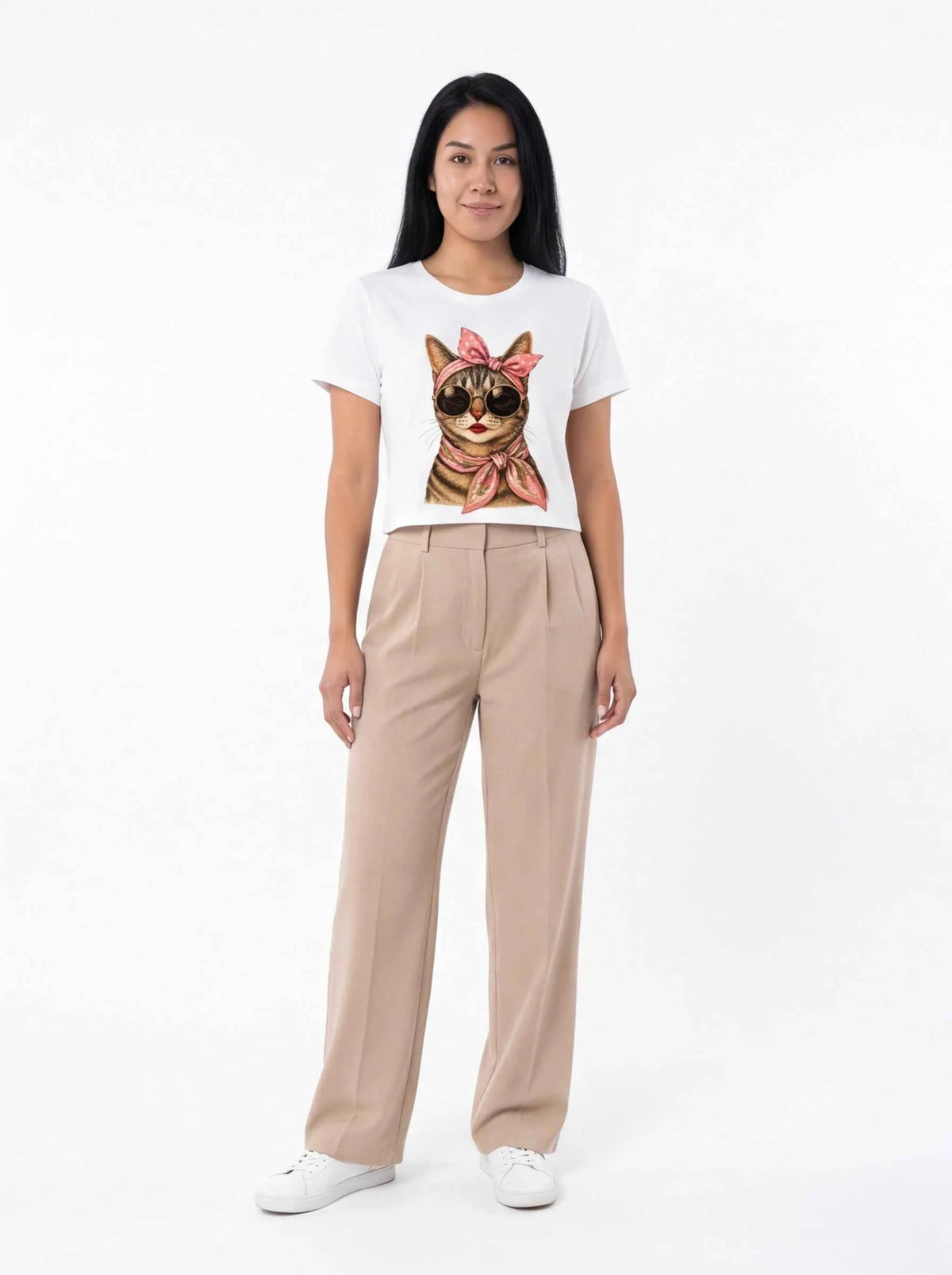 White cat graphic T-shirt with pink bow, worn with beige pants