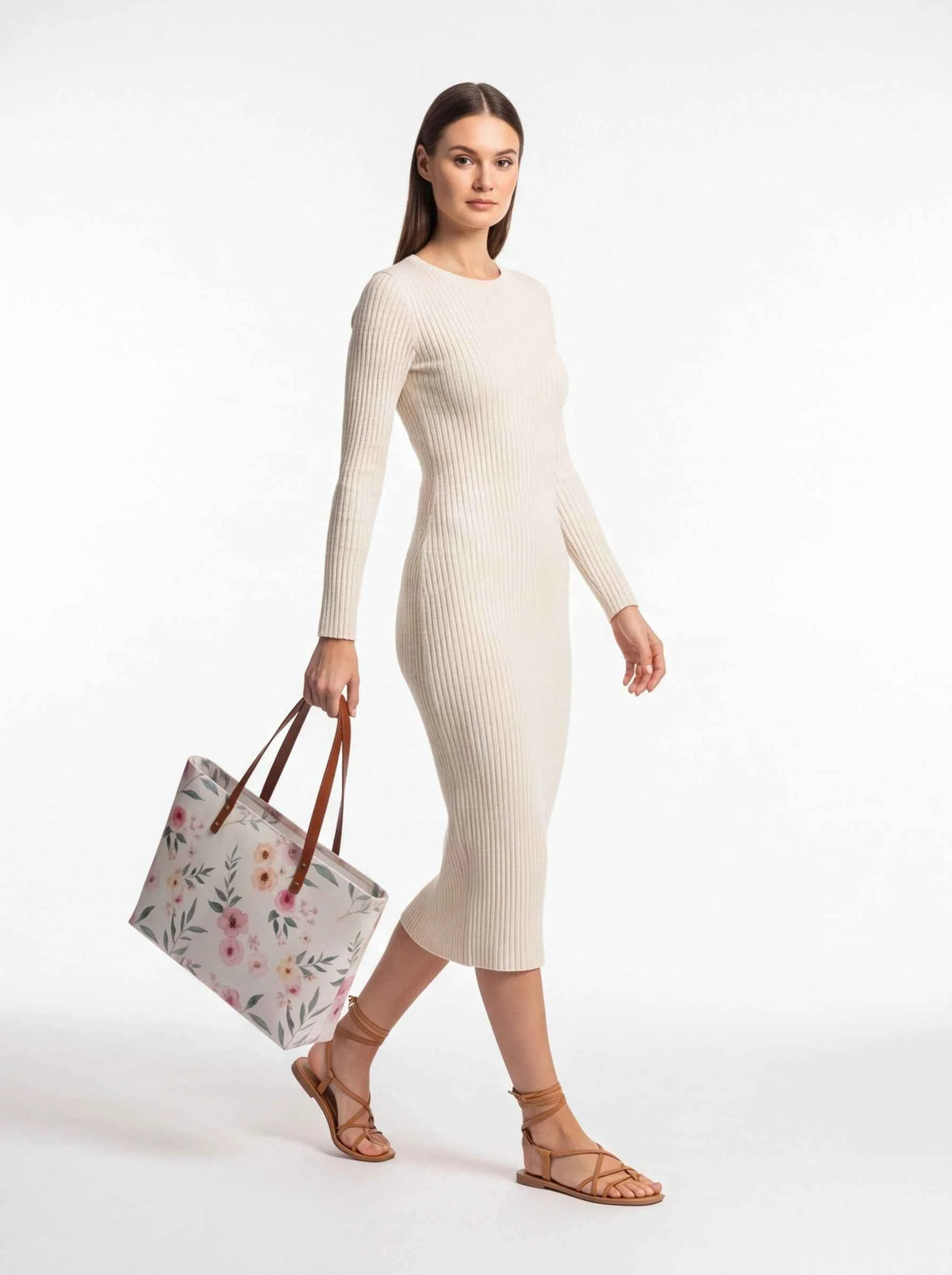 White floral tote bag with pink flowers and brown leather handles on model