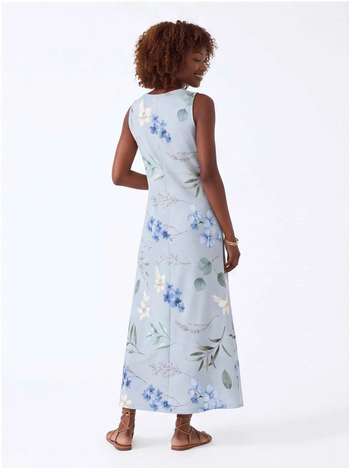White sleeveless V-neck maxi dress with blue floral and green leaf print, side view