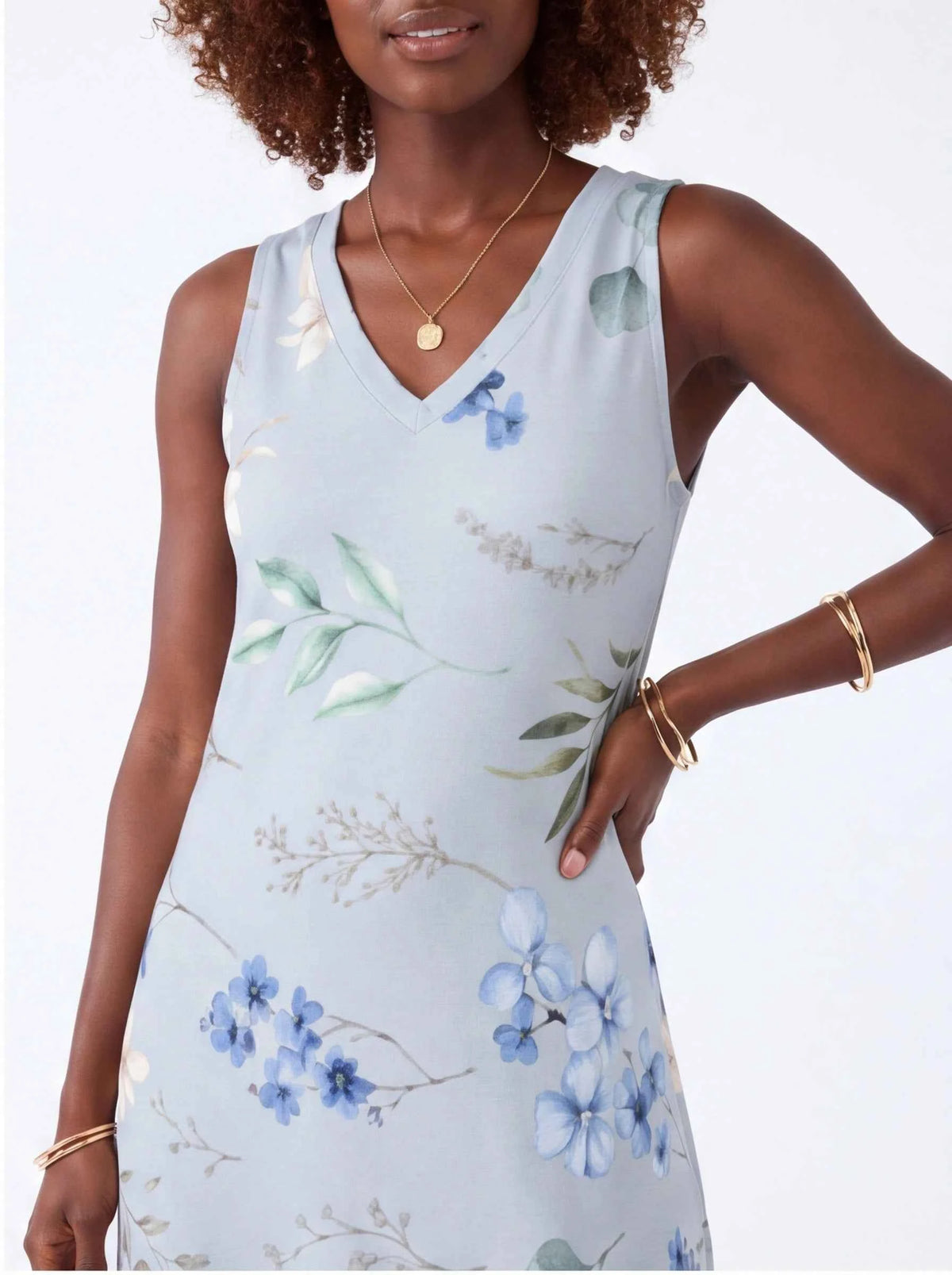 White sleeveless V-neck maxi dress bodice with blue floral and green leaf print