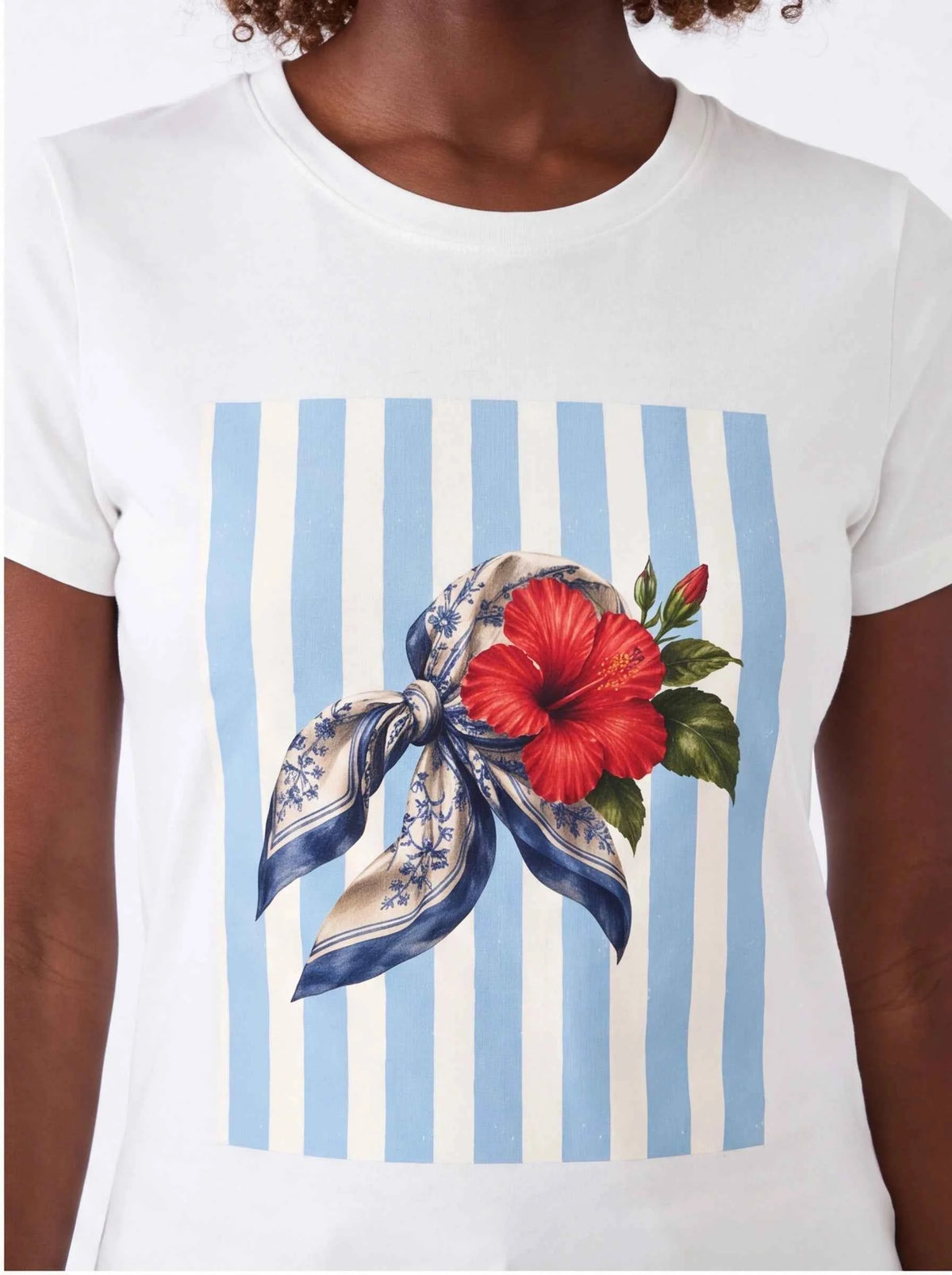 White crew-neck T-shirt with blue vertical stripes and red hibiscus ribbon bow