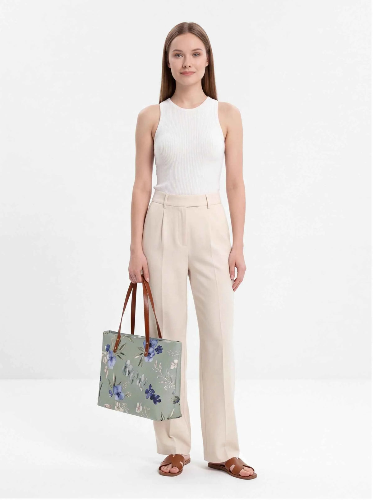 Floral beach tote with brown handles carried at the side