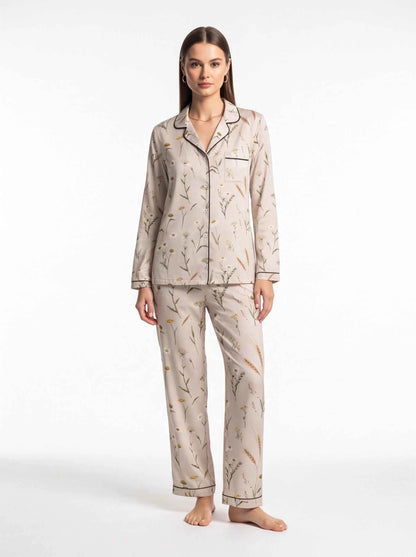 Women's satin lounge pajama set with button-front top and matching floral trousers, cream