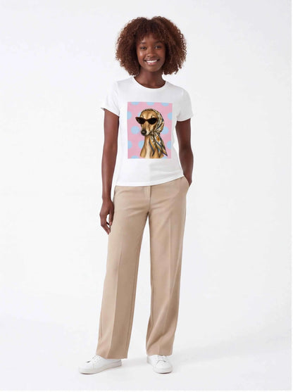 White graphic t-shirt with dog portrait print, styled with beige pants