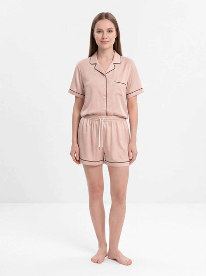 Soft peach satin short pajama set with button-up top and tie-waist shorts