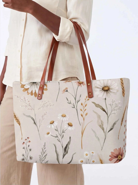 White floral tote bag with brown leather-look straps and roomy rectangular shape.