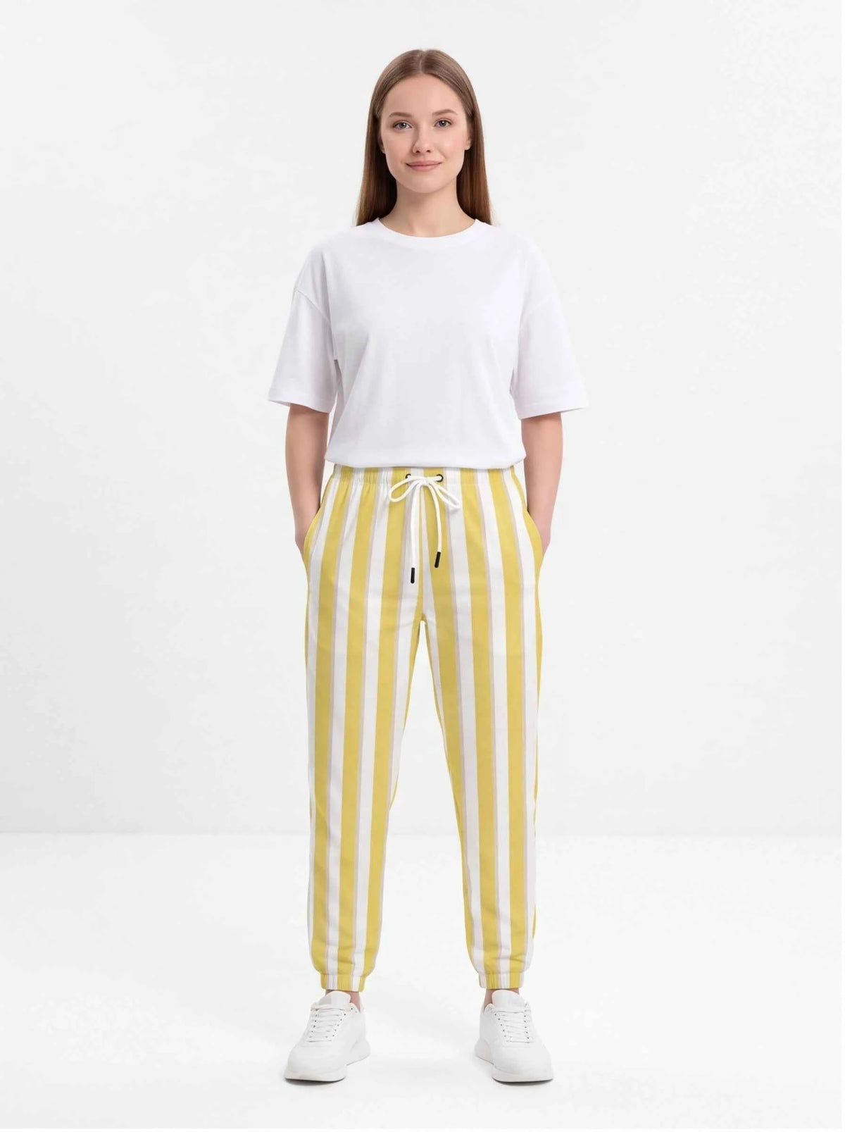 Yellow and white striped cotton jogger pants with drawstring waist and tapered cuffs