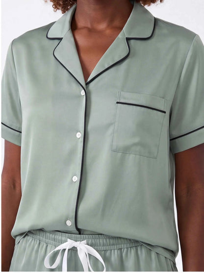 Sage satin pajama shirt detail with pocket, button front, and contrast trim