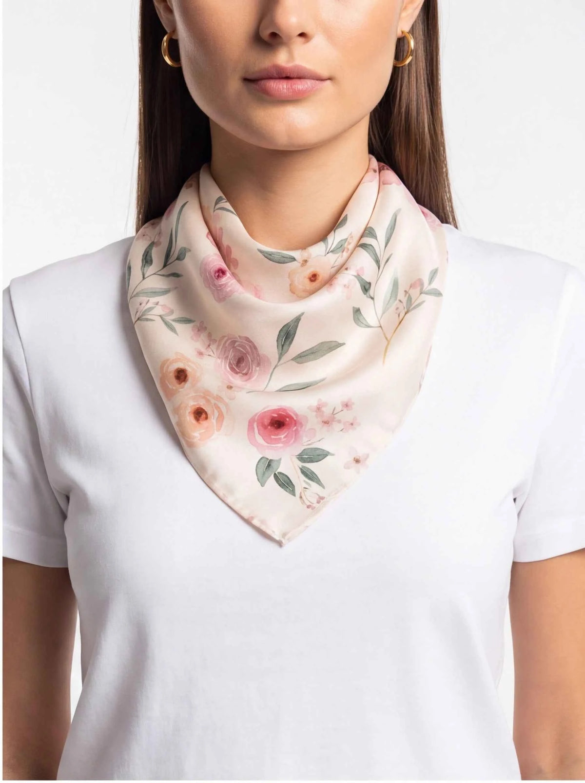 Silk bandana close-up: white fabric with blush flowers and green leaves