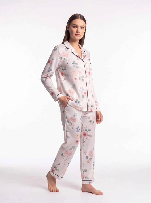 Women's satin lounge pajama set with button-front top and floral print trousers, pale pink