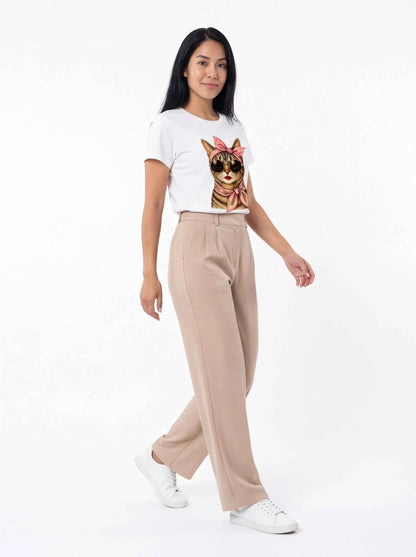 White cat graphic T-shirt with pink bow, side view with beige pants